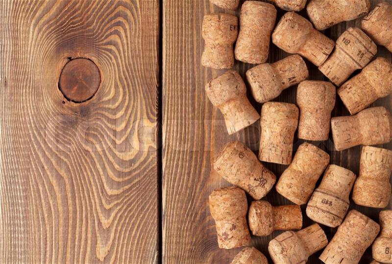Champagne wine corks over wooden table texture background, stock photo