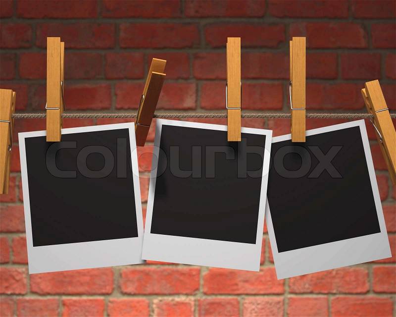 Old photographs hanging on the clothesline stuck for wooden clamps. Clipping path in the dark area of each photo, stock photo