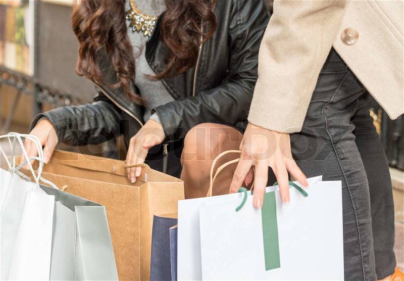 Shopping in city center. Woman legs and gift bags, stock photo