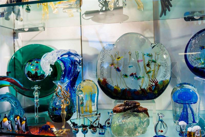 VENICE, ITALY - JUNE 1, 2014: Murano glass on display in window shop in market, Venice. Murano glass is a famous product of the Venetian island of Murano, traditional manufacturing centre.Glass-work in Murano island, stock photo