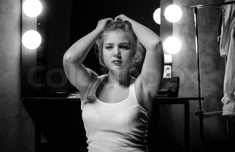 Closeup black and white portrait os sexy slim woman posing at dressing room, stock photo