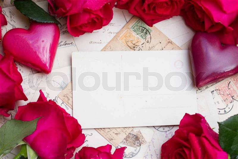 Vintage background with frame of hearts and fresh roses, stock photo