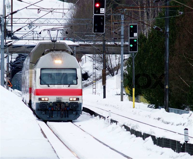 Train arriving at station with snow at winter, stock photo