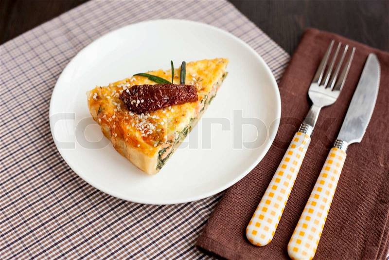 Piece of pie with spinach and fish salmon, stock photo