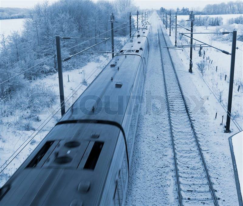 Danish intercity train on a cold December day in the countryside, stock photo