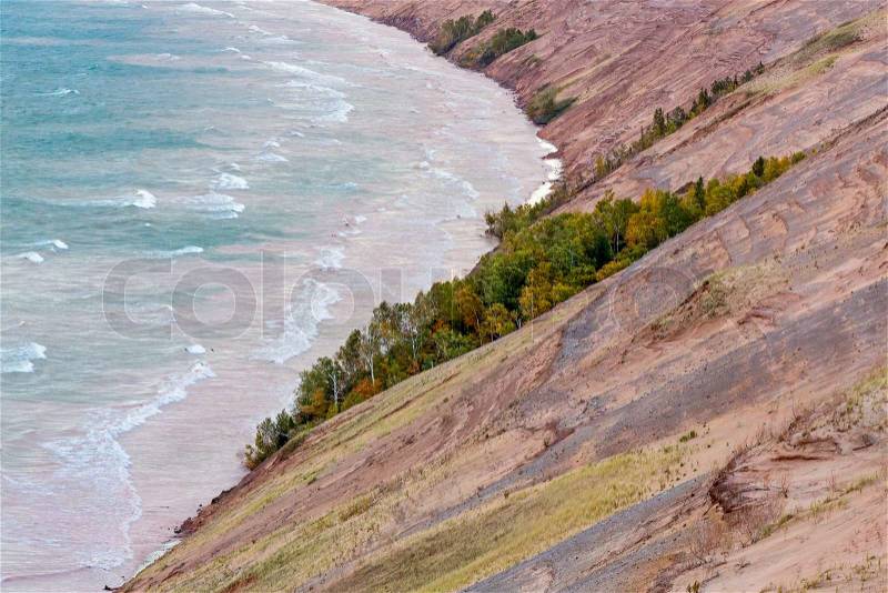 The Grand Sable Dunes, seen here in the light of an early autumn morning, steeply rise from the shore of Lake Superior near Grand Marais, Michigan in Pictured Rocks National Lakeshore park, stock photo