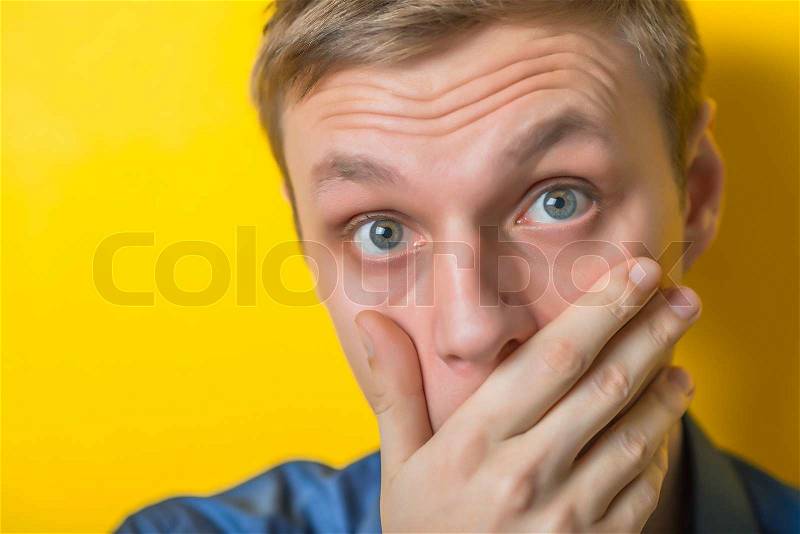 Young man covering his mouth , stock photo