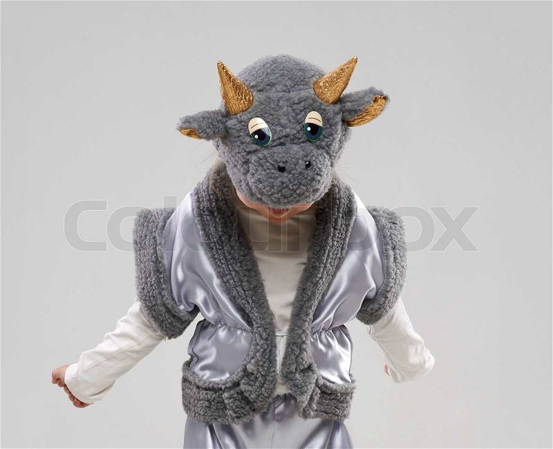 Funny girl in cow costume looks down, stock photo
