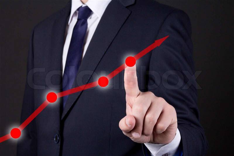 Businessman finger touching red rising arrow over dark background, stock photo