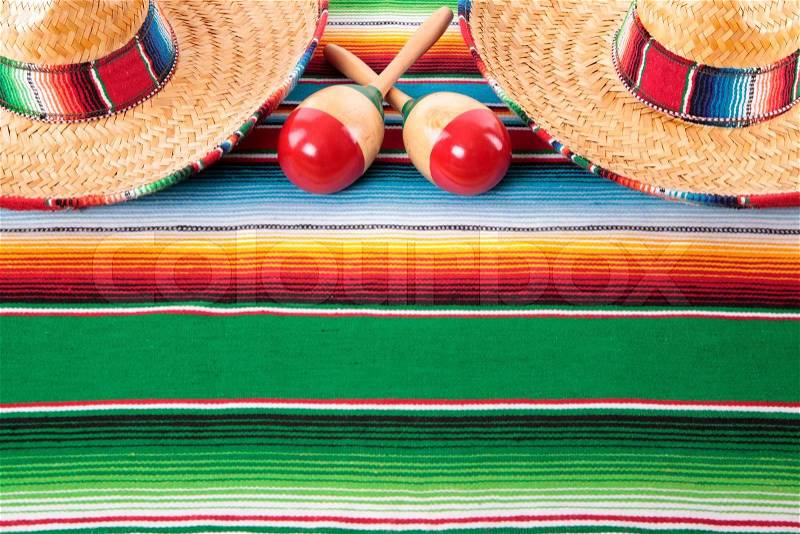 Mexican sombreros and maracas on a traditional serape blanket. Space for copy, stock photo