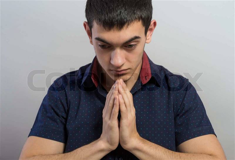 Portrait of praying businessman , stock photo
