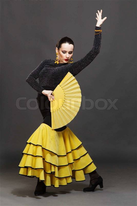 Flamenco dancer in a yellow skirt, stock photo