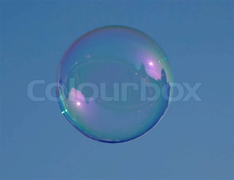 Bubble blown from water and soap against a blue sky, stock photo