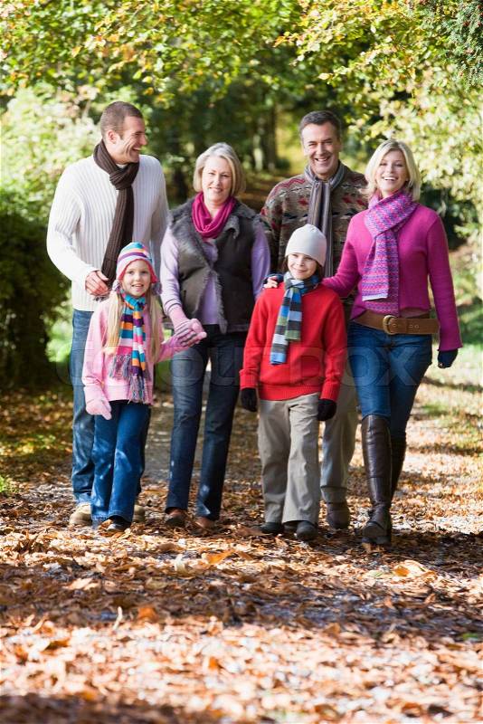 Multi-generation family on walk through autumn woods, stock photo
