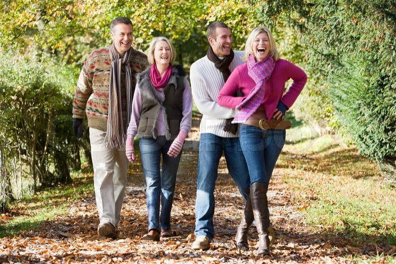 Family group walking through autumn woods, stock photo