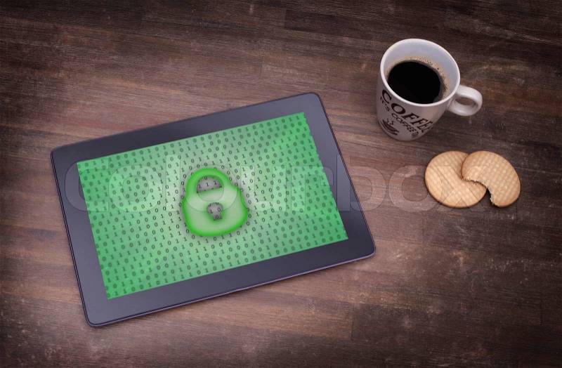 Tablet on a desk, concept of data protection, green, stock photo