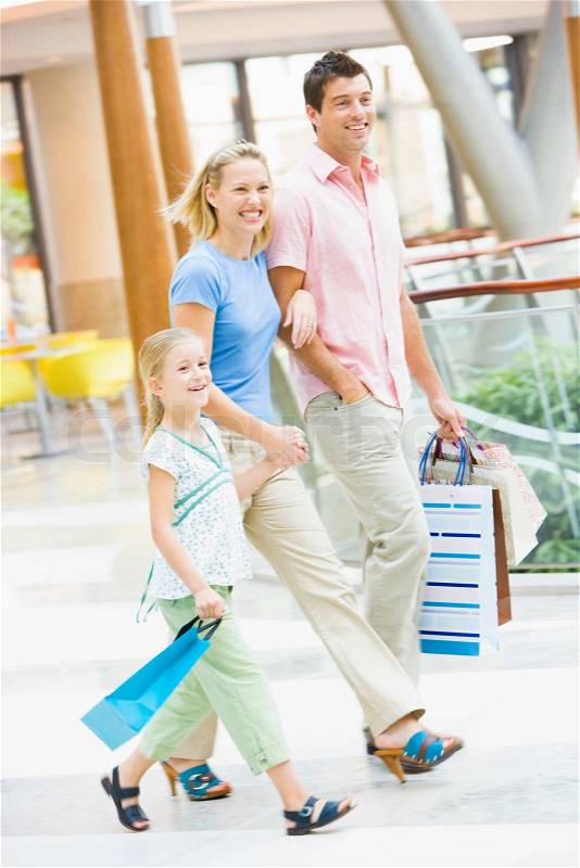 Family shopping in mall carrying mall, stock photo
