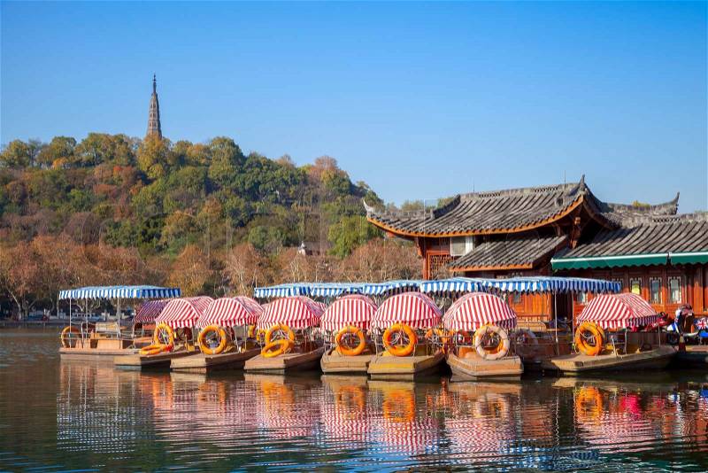 Chinese recreation boats are moored on the West Lake coast. Famous park in Hangzhou city, China, stock photo