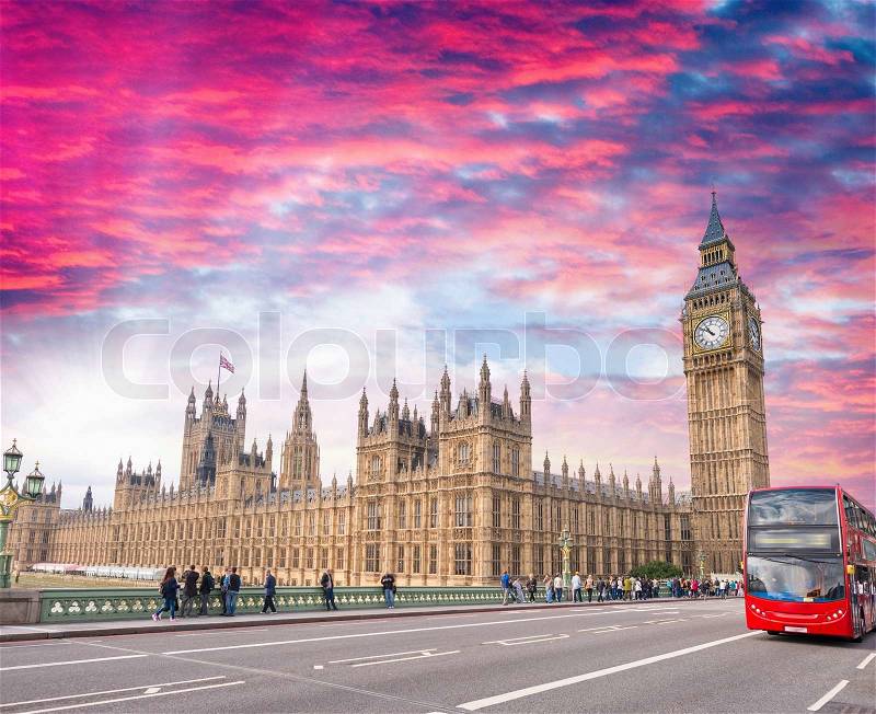 Red bus crossing Westminster Bridge, London, stock photo