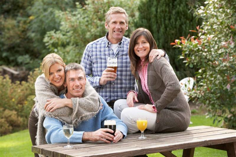 Group Of Friends Outdoors Enjoying Drink In Pub Garden, stock photo