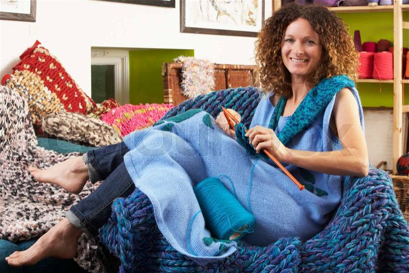 Woman Sitting In Chair Knitting, stock photo