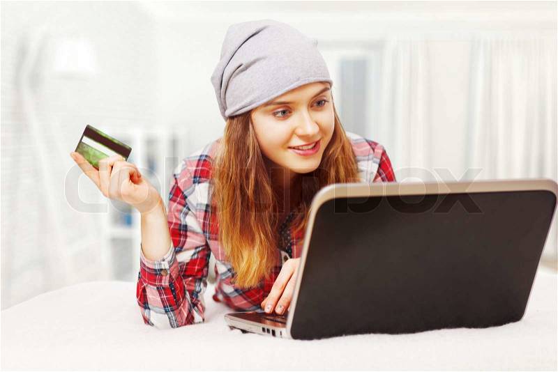 Young woman shopping online with a credit card, stock photo
