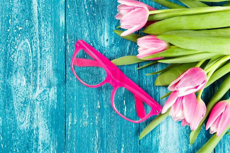 Beautiful pink tulips on blue wood background, stock photo