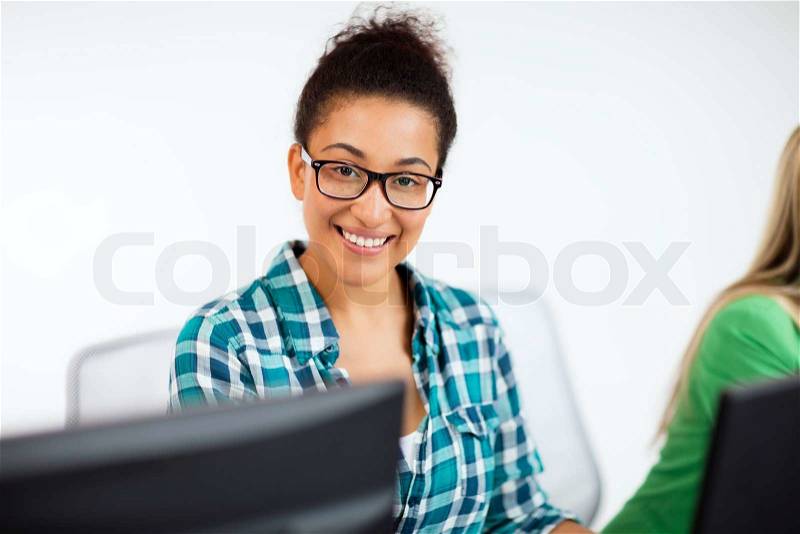 Education, technology and internet - african student with computer studying at school, stock photo