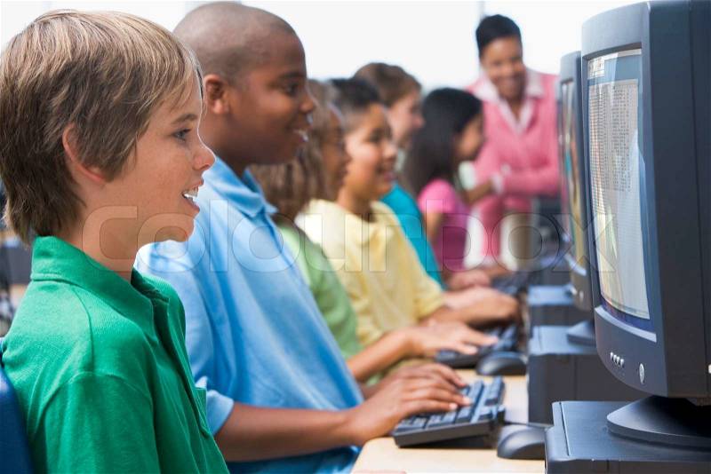 Male pupil in elementary school computer class, stock photo
