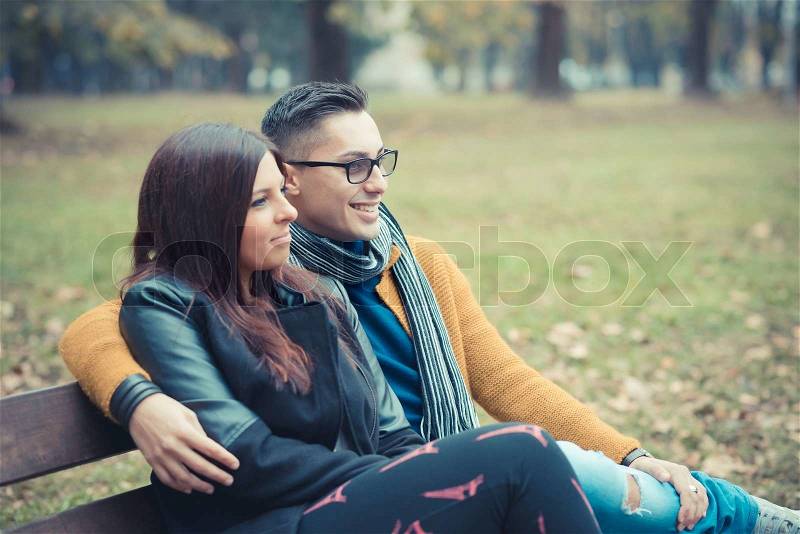 Young couple in the park during autumn season outdoor - lovers valentine , stock photo