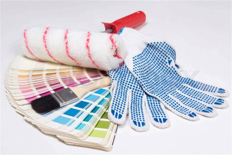 Painter\'s tools - brushes, work gloves and colorful palette over white background, stock photo