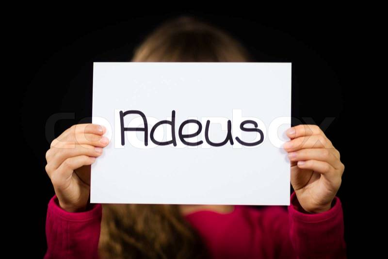 Studio shot of child holding a sign with Portuguese word Adeus - Goodbye, stock photo