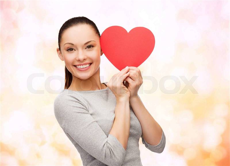 Happiness, love and health concept - smiling asian woman with red heart, stock photo