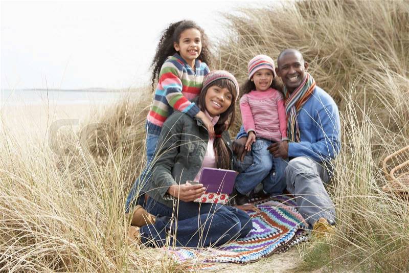 Cheerful black family on a beach, stock photo