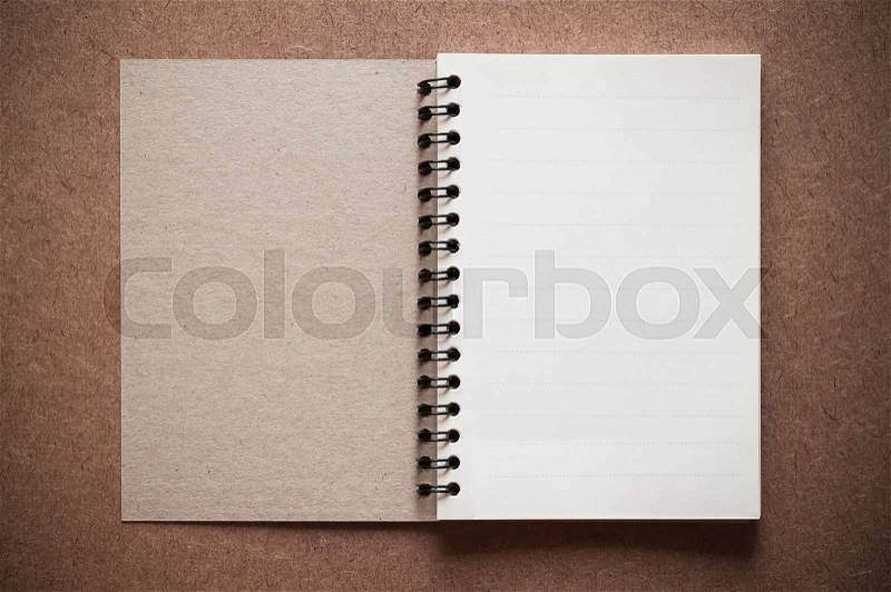 Blank spiral binder notebook on wooden background, stock photo