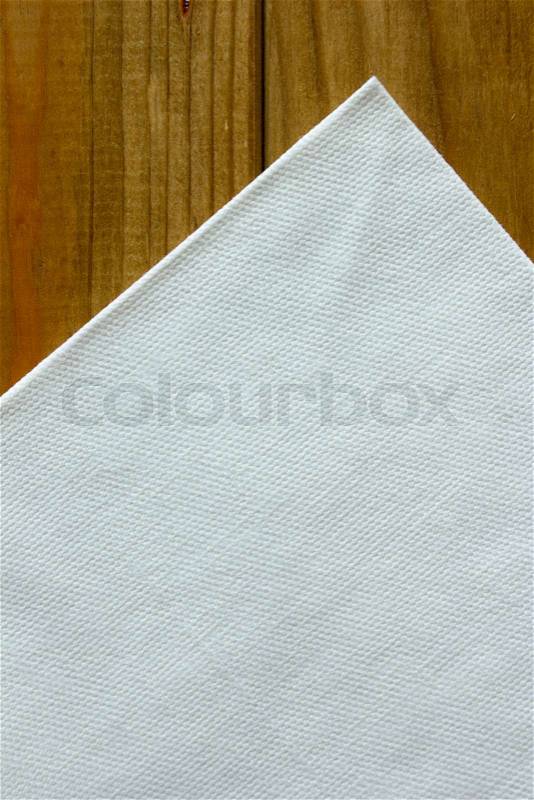 White paper napkins on wooden table. Table accessory, stock photo