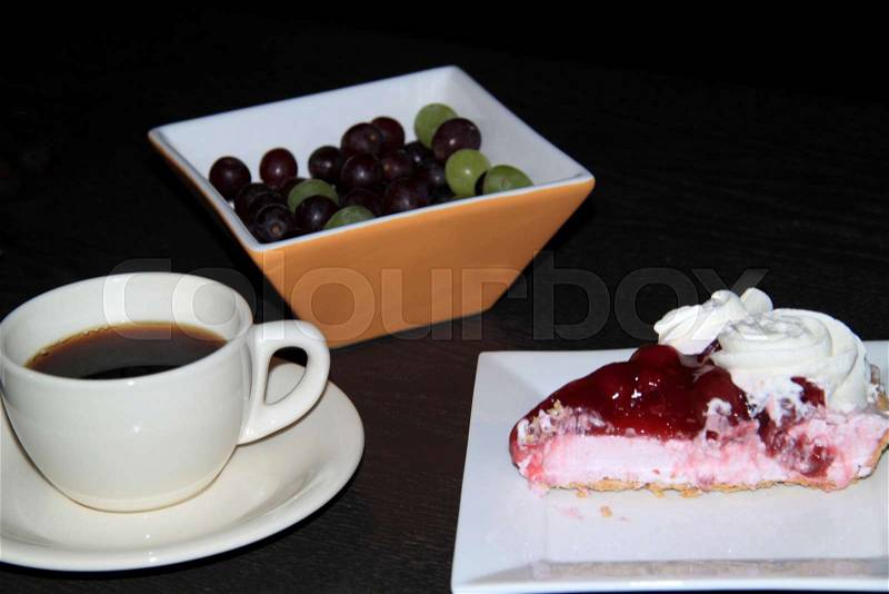 Cherry cake with a cup of coffee and bowl of grapes, stock photo