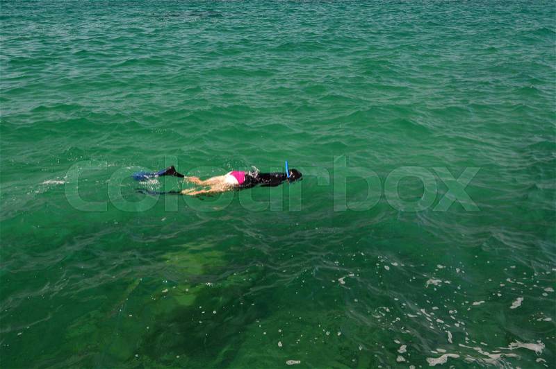 Beautiful women with flippers, mask and tube snorkeling in Thailand island, stock photo