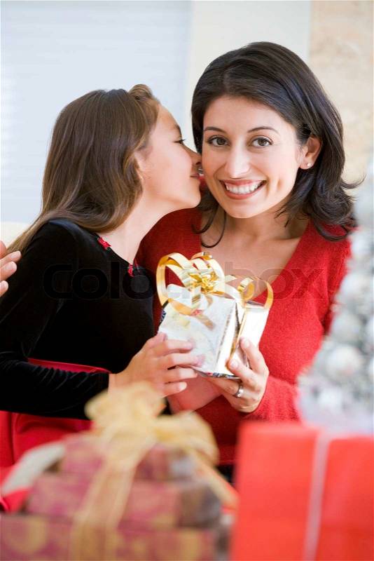 A latin-american mother and her daughter celebrating Christmas day, stock photo