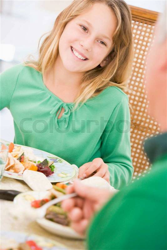 A young girl enjoying her Christmas meal, stock photo