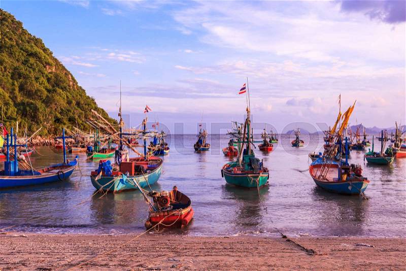 Group of fishing boat anchored at Pranburi beach in Thailand, stock photo