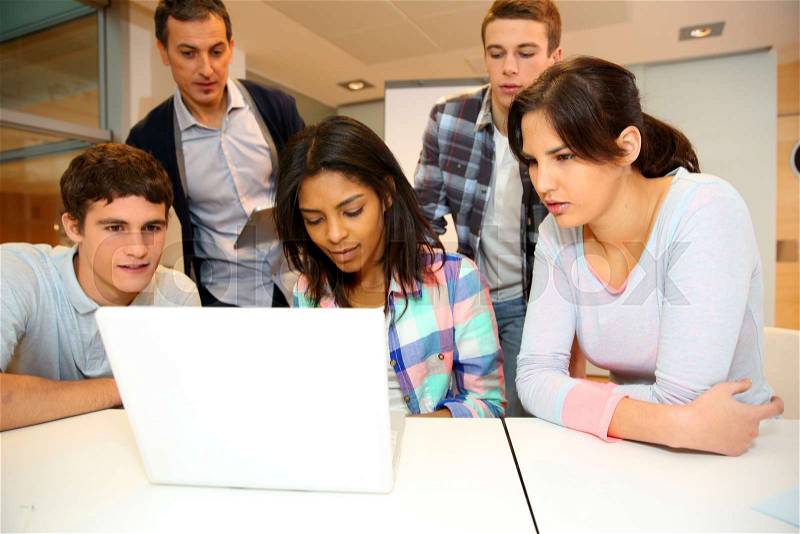 Group of students in computer training with teacher, stock photo