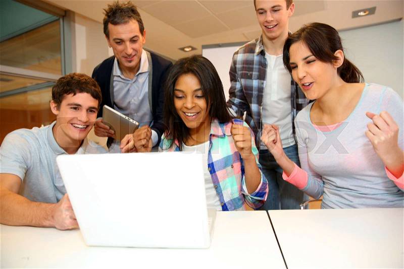 Group of students in computer training with teacher, stock photo