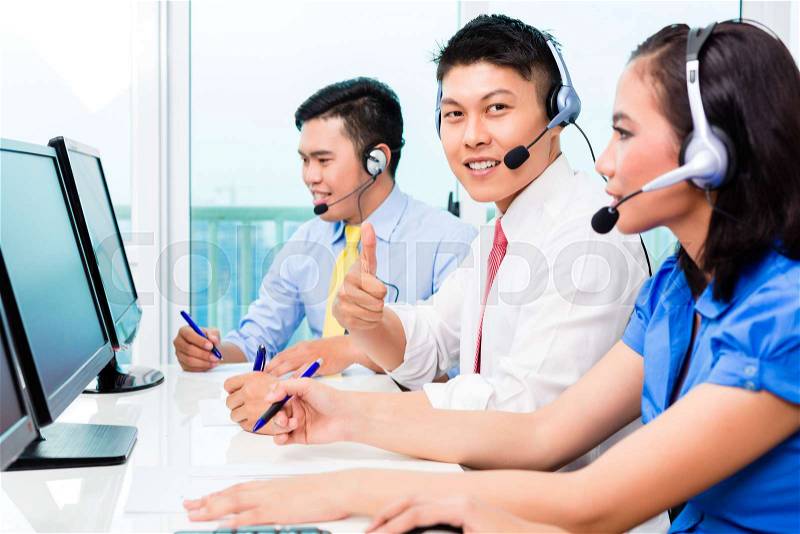 Asian Chinese call center agent team on phone, stock photo
