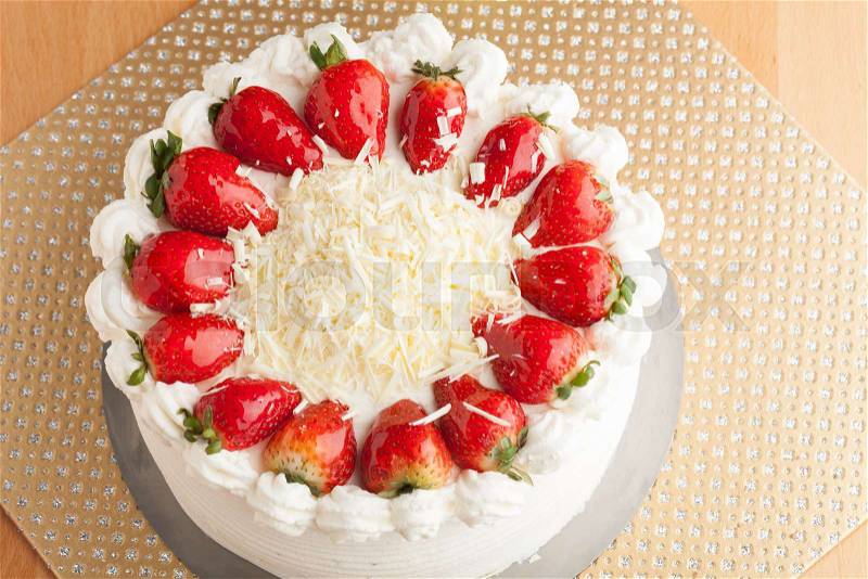 Top view of an entire strawberry shortcake with white chocolate shavings, stock photo