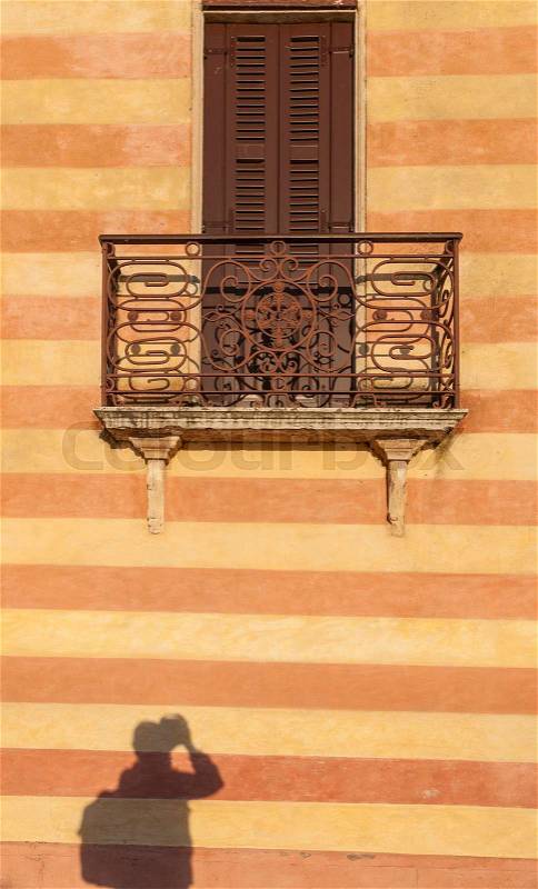 Door with balcony in venetian style on Verona street, Italy, stock photo