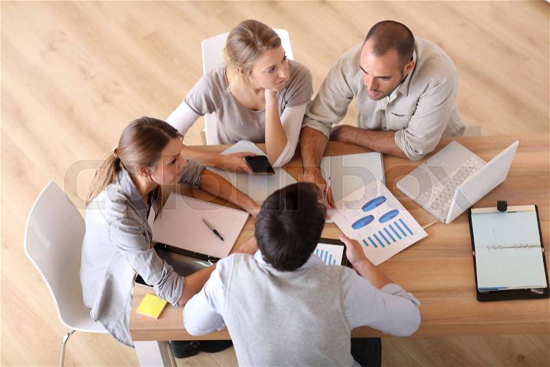 Upper view of business people around table, stock photo