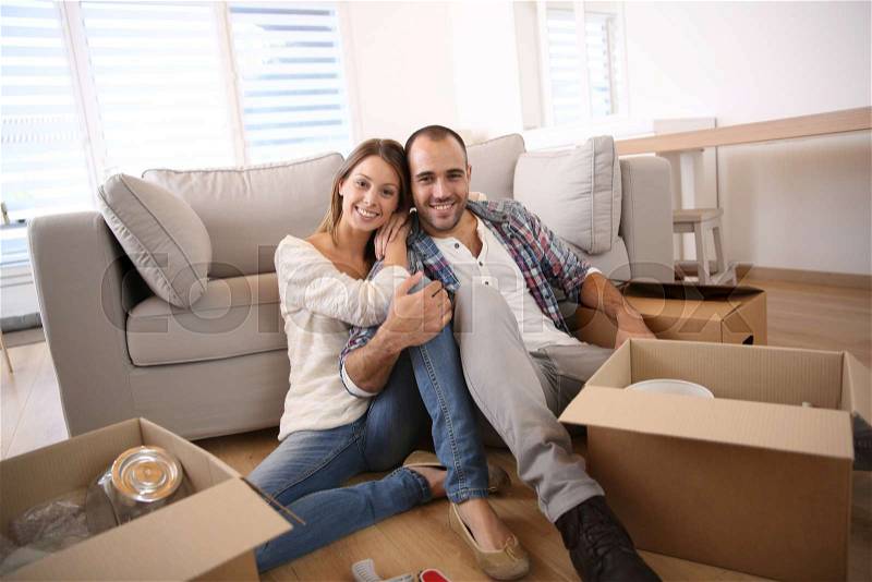 Young adults moving in new home, stock photo