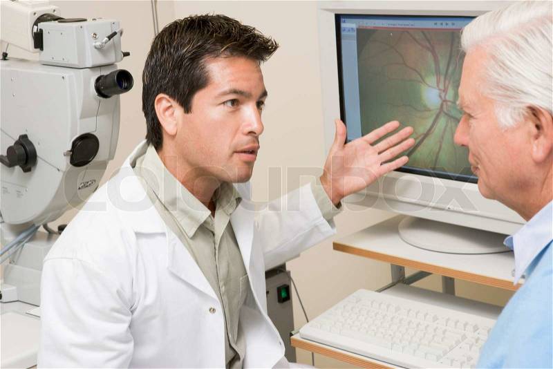Doctor Explaining Eye Exam Results To Patient, stock photo