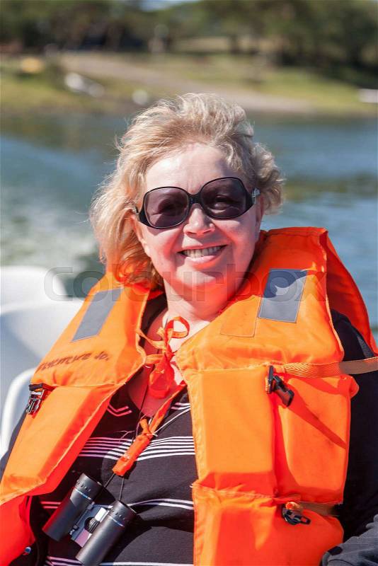 Portrait of a woman with life jacket, sunglasses and binoculars. health and fitness, stock photo